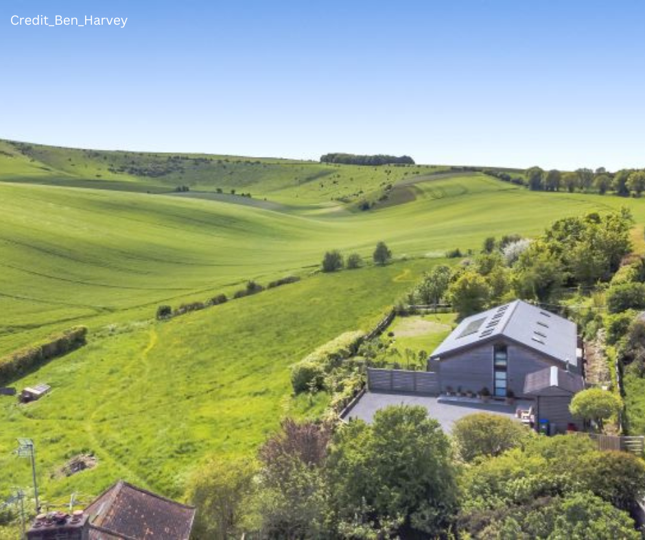 Grain Store, Lewes House in rolling downs green countryside.