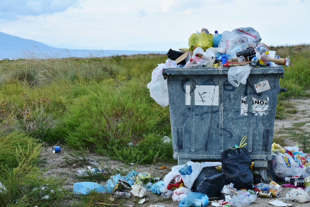Blog header image A bin full of rubbish in the countryside