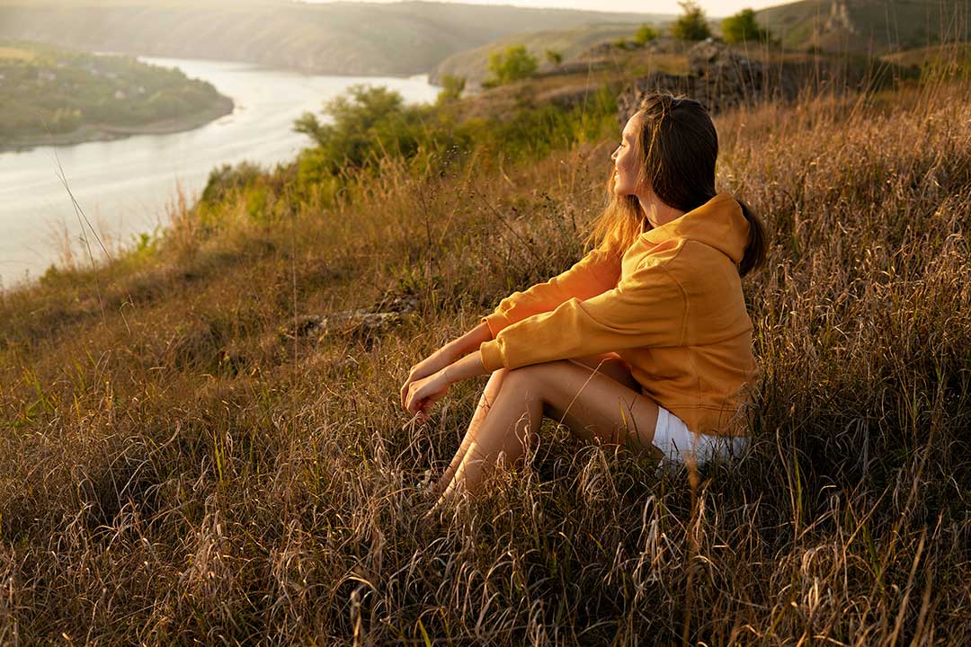 GT-side-view-woman-sitting-outdoors